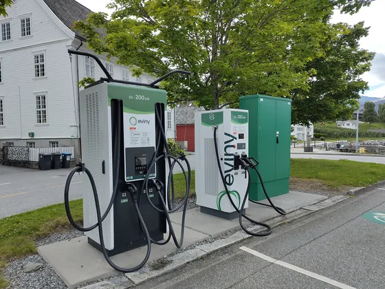 Two EV charging stations beside a car park